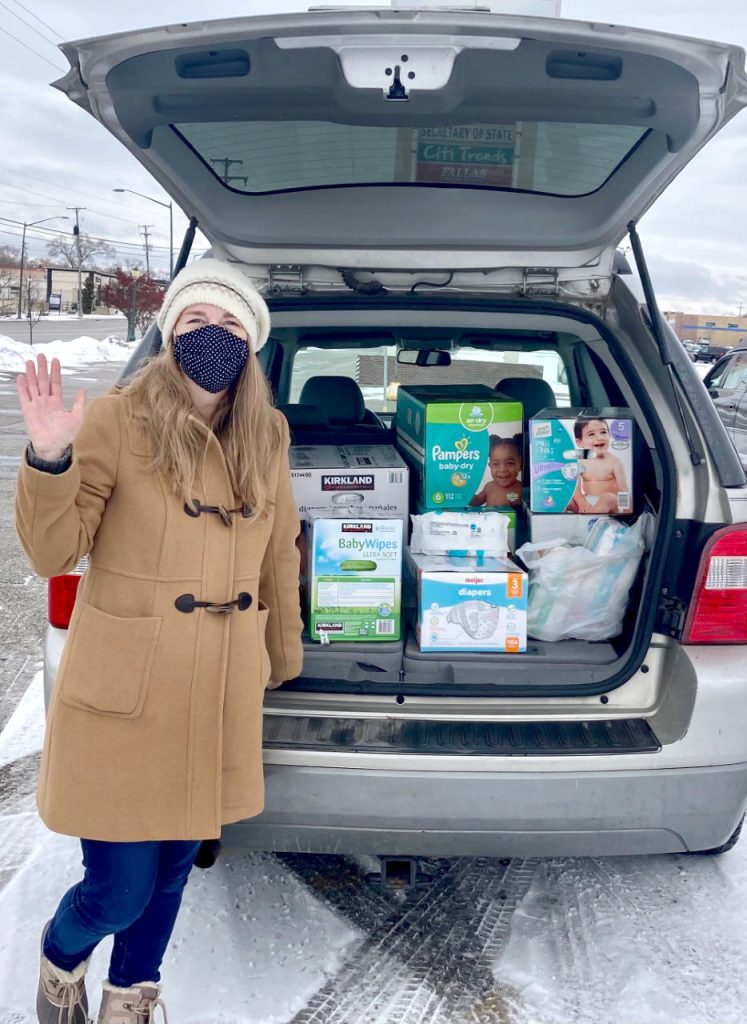 diapers in trunk with lady next to car