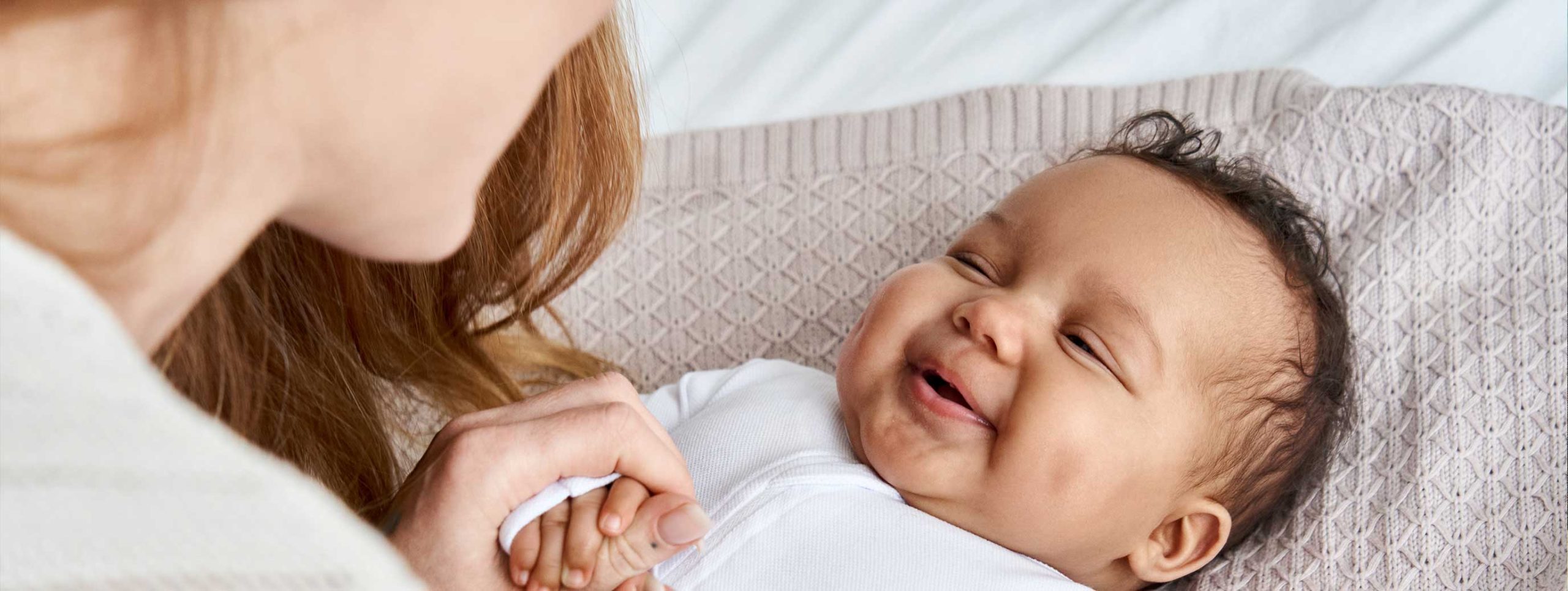 baby looking up smiling